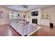 Bright living room featuring a fireplace, built-in shelving, and hardwood floors at 4895 Sterling Close, Buford, GA 30518