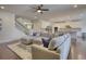 Open-concept living room with hardwood floors, a sectional sofa, and staircase view at 4895 Sterling Close, Buford, GA 30518