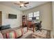 Living room with a love seat, ceiling fan, wooden desk and hardwood floors at 4895 Sterling Close, Buford, GA 30518