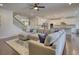 Open-concept living space featuring hardwood floors, stairs, and access to the kitchen at 4895 Sterling Close, Buford, GA 30518