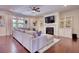 Spacious living room featuring hardwood floors, a fireplace, built-in cabinets, and a large sectional couch at 4895 Sterling Close, Buford, GA 30518