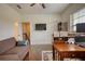 Living room with a love seat, ceiling fan, wooden desk and hardwood floors at 4895 Sterling Close, Buford, GA 30518