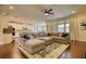 Open concept living room and kitchen area with hardwood floors and large sectional sofa at 4895 Sterling Close, Buford, GA 30518
