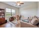 Living room with a love seat, ceiling fan, wooden desk and hardwood floors at 4895 Sterling Close, Buford, GA 30518