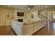 Comfortable living room with hardwood floors, a fireplace, built-in cabinets, and a large gray sectional couch at 4895 Sterling Close, Buford, GA 30518