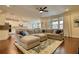 Spacious living room with a ceiling fan, large sectional, and hardwood floors at 4895 Sterling Close, Buford, GA 30518