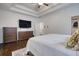 Spacious main bedroom with a television, dresser, and a walk-in closet for ample storage and convenience at 4895 Sterling Close, Buford, GA 30518