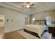 Bedroom with hardwood floors, tray ceiling, ceiling fan, and neutral walls at 4895 Sterling Close, Buford, GA 30518