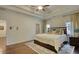 Elegant main bedroom with a tray ceiling, hardwood floors, and neutral color scheme creating a serene atmosphere at 4895 Sterling Close, Buford, GA 30518