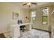 Well-lit home office with large windows, a sleek white desk, and a comfortable executive chair at 4895 Sterling Close, Buford, GA 30518