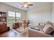 Cozy office with hardwood floors, a comfortable couch, a built-in bookcase, and a window view at 4895 Sterling Close, Buford, GA 30518