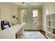 Bright and airy home office featuring large windows, a clean white desk, and stylish decor accents at 4895 Sterling Close, Buford, GA 30518