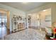 Open playroom with hardwood floors, neutral walls, and a built-in shelving unit for storage at 4895 Sterling Close, Buford, GA 30518