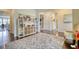 Open playroom with hardwood floors, storage shelving, and view to kitchen at 4895 Sterling Close, Buford, GA 30518