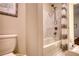 The shower features a bathtub, a gray and white shower curtain, and marble-look tile at 4895 Sterling Close, Buford, GA 30518