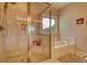 Elegant bathroom with glass-enclosed shower, soaking tub and large window at 4895 Sterling Close, Buford, GA 30518