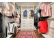 Walk-in closet features custom shelving, hanging rods, and a colorful rug at 4895 Sterling Close, Buford, GA 30518