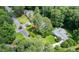 Aerial view of a house surrounded by lush greenery in a serene neighborhood at 6175 Weatherly Dr, Sandy Springs, GA 30328