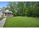 Expansive backyard with lush green lawn, deck, and mature trees at 6175 Weatherly Dr, Sandy Springs, GA 30328