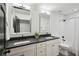Bathroom features a double vanity with gray countertops, subway tile in the shower, and modern fixtures at 6175 Weatherly Dr, Sandy Springs, GA 30328