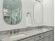 Bathroom features a double vanity with marble countertops and oval mirrors with views of the shower at 6175 Weatherly Dr, Sandy Springs, GA 30328