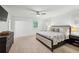 Spacious bedroom featuring carpet, ceiling fan, and a window with plantation shutters at 6175 Weatherly Dr, Sandy Springs, GA 30328