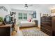 Bedroom featuring hardwood floors, desk, and a window with plantation shutters at 6175 Weatherly Dr, Sandy Springs, GA 30328