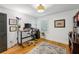 Bedroom showcases a work desk, hardwood floors, and a window with plantation shutters at 6175 Weatherly Dr, Sandy Springs, GA 30328