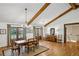 Dining room with exposed wood beams, hardwood floors, and french doors to outdoor scenery at 6175 Weatherly Dr, Sandy Springs, GA 30328