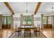Elegant dining room with wood floors, french doors, neutral colors, and natural light at 6175 Weatherly Dr, Sandy Springs, GA 30328