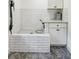 Dog wash station with white subway tile, herringbone floors, spray nozzle and storage cabinets at 6175 Weatherly Dr, Sandy Springs, GA 30328