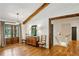 Stylish foyer featuring hardwood floors, wood beams, and a decorative dresser, creating a warm and inviting entrance at 6175 Weatherly Dr, Sandy Springs, GA 30328
