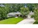 Charming single-story home with a beautifully landscaped front yard and attached two-car garage at 6175 Weatherly Dr, Sandy Springs, GA 30328