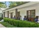 Inviting front porch with rocking chairs, double entry doors, and well-manicured landscaping at 6175 Weatherly Dr, Sandy Springs, GA 30328