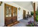 Charming front porch with rocking chairs, double doors, and stylish decor, creating a welcoming entrance at 6175 Weatherly Dr, Sandy Springs, GA 30328