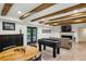 Inviting game room with foosball table, fireplace, seating, and elegant furnishings at 6175 Weatherly Dr, Sandy Springs, GA 30328