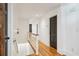Bright hallway with hardwood floors and white trim, offering a clean and modern aesthetic at 6175 Weatherly Dr, Sandy Springs, GA 30328