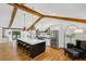Bright kitchen with white cabinets, oversized island, wooden beams, stainless steel appliances, and hardwood floors at 6175 Weatherly Dr, Sandy Springs, GA 30328