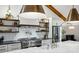 Bright open kitchen with marble counters, stainless steel appliances, and open shelving at 6175 Weatherly Dr, Sandy Springs, GA 30328