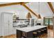 Modern kitchen with white and grey cabinets, oversized island with seating, stainless steel appliances, and hardwood floors at 6175 Weatherly Dr, Sandy Springs, GA 30328