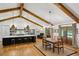 Open concept kitchen and dining area with wood beams, hardwood floors, and natural light at 6175 Weatherly Dr, Sandy Springs, GA 30328