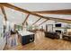 Spacious living room with vaulted ceiling, wood beams, fireplace, open floor plan and hardwood floors at 6175 Weatherly Dr, Sandy Springs, GA 30328