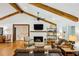 Spacious living room with vaulted ceilings, fireplace, and exposed wood beams, creating a warm and inviting atmosphere at 6175 Weatherly Dr, Sandy Springs, GA 30328