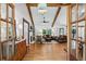 Inviting living room with exposed wood beams, fireplace, and an open entryway, creating a warm and welcoming atmosphere at 6175 Weatherly Dr, Sandy Springs, GA 30328