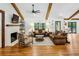 Cozy living room with a brick fireplace, wood beams, comfortable seating, and plenty of natural light at 6175 Weatherly Dr, Sandy Springs, GA 30328