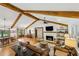 Open-concept living space featuring vaulted ceilings with exposed wood beams, connecting the living, dining, and kitchen areas at 6175 Weatherly Dr, Sandy Springs, GA 30328