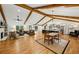 Expansive open floor plan with exposed beams, hardwood floors, fireplace, and a combined living, dining, and kitchen area at 6175 Weatherly Dr, Sandy Springs, GA 30328