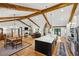 Open concept living space with kitchen, dining, and living room featuring hardwood flooring and wood beams at 6175 Weatherly Dr, Sandy Springs, GA 30328