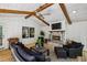 Cozy sunroom featuring a fireplace, ceiling fan, and comfortable seating with backyard views at 6175 Weatherly Dr, Sandy Springs, GA 30328