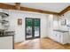 Modern wet bar with wine storage, cabinets and hardwood floors, next to French doors to the deck at 6175 Weatherly Dr, Sandy Springs, GA 30328